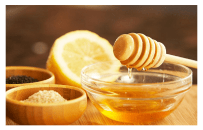 Honey dripping in glass bowl