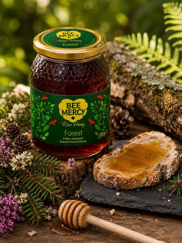 A jar of Bee Mercy Forest Raw Honey styled on a rustic wooden surface with a slice of bread, a honey dipper, and natural forest props like pinecones and ferns.