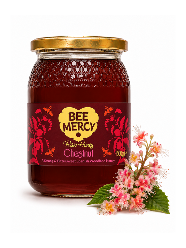 A 500g glass jar of Bee Mercy Raw Honey Chestnut, filled with deep reddish-brown honey and topped with a gold lid, shown next to pink and white chestnut blossom flowers on a white background.